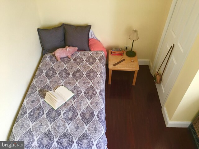 bedroom with dark hardwood / wood-style floors