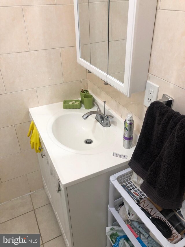 bathroom with tile walls, tasteful backsplash, vanity, and tile patterned floors