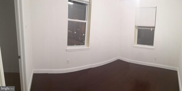 unfurnished room with hardwood / wood-style flooring