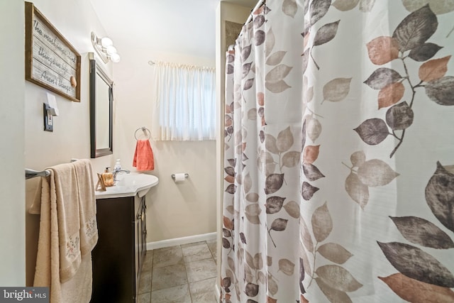 bathroom with walk in shower and vanity