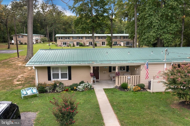 view of front facade with a front yard and a porch