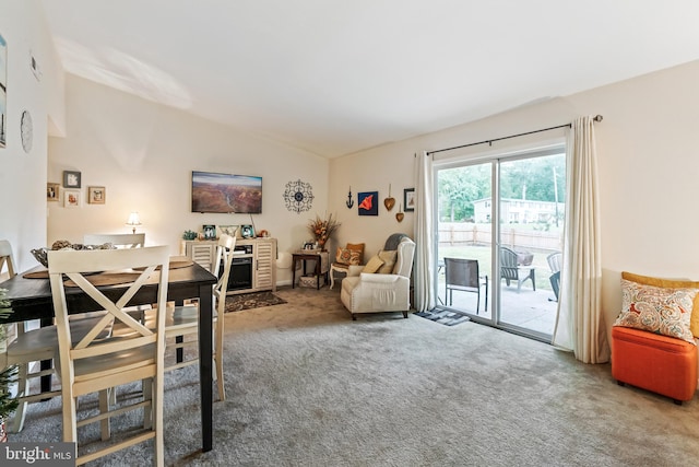 dining area featuring lofted ceiling and carpet flooring