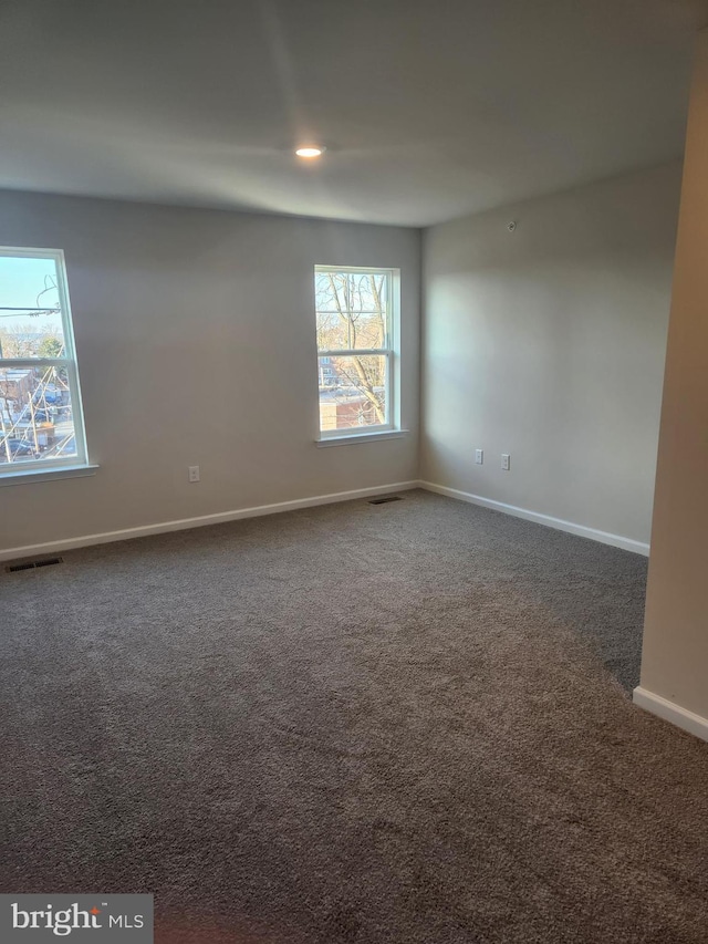 empty room with dark carpet