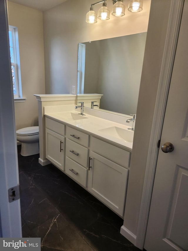 bathroom featuring vanity and toilet