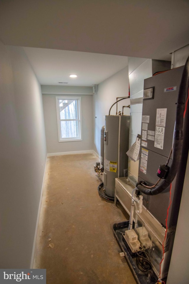 utility room featuring electric water heater and heating unit