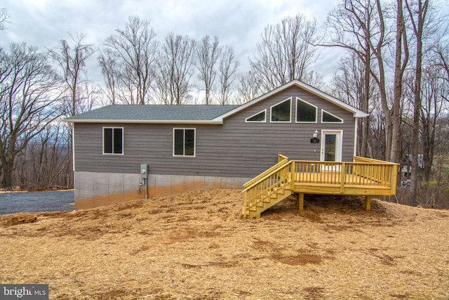 back of property with stairs and a wooden deck