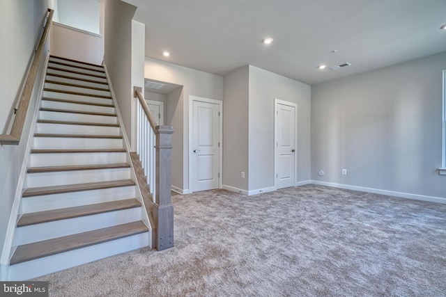 stairs featuring carpet