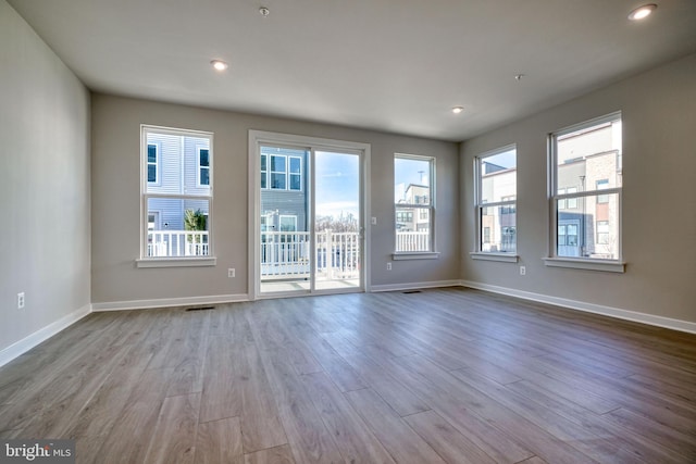 unfurnished room with light hardwood / wood-style flooring and a wealth of natural light