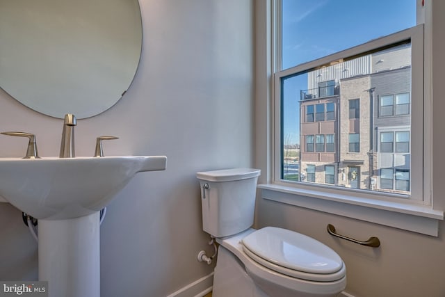 bathroom with plenty of natural light and toilet