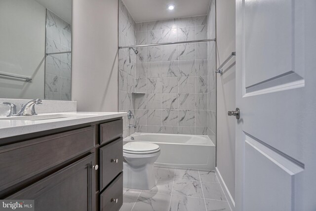 full bathroom featuring vanity, toilet, and tiled shower / bath