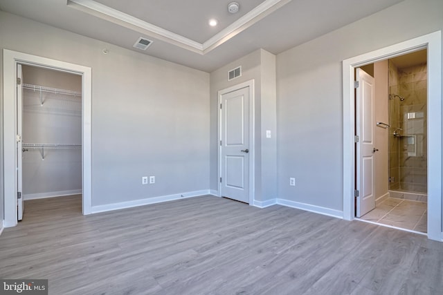 unfurnished bedroom featuring light wood-type flooring and a closet