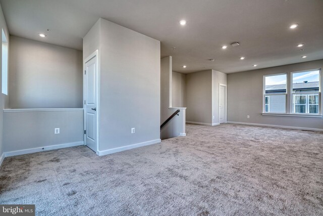 unfurnished room featuring light colored carpet