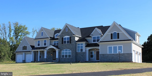 view of front of house featuring a garage and a front lawn