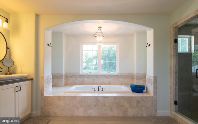 bathroom featuring independent shower and bath, vanity, and tile patterned floors