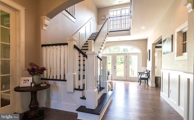 foyer entrance with dark hardwood / wood-style floors and french doors