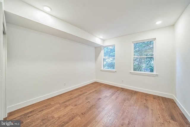 unfurnished room with hardwood / wood-style flooring