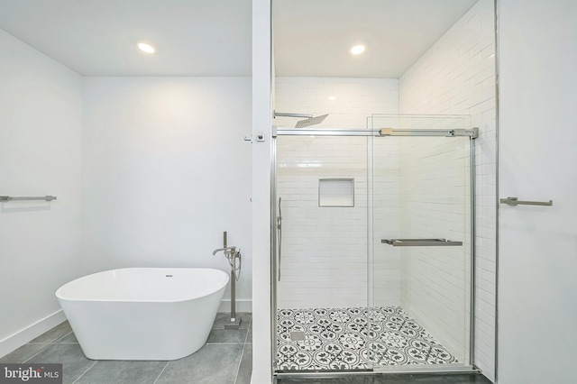 bathroom featuring plus walk in shower and tile patterned floors