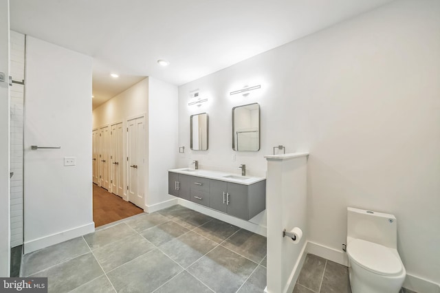 bathroom featuring vanity, toilet, and tile patterned floors