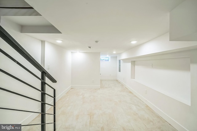 basement with light hardwood / wood-style floors