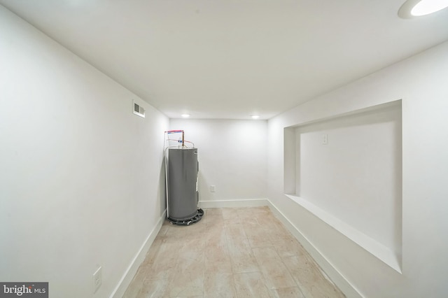 interior space featuring light wood-type flooring and water heater