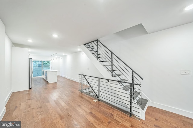 stairway featuring wood-type flooring