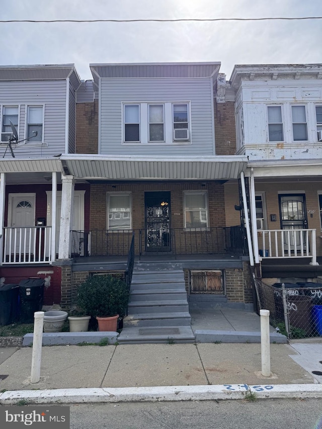 townhome / multi-family property featuring covered porch