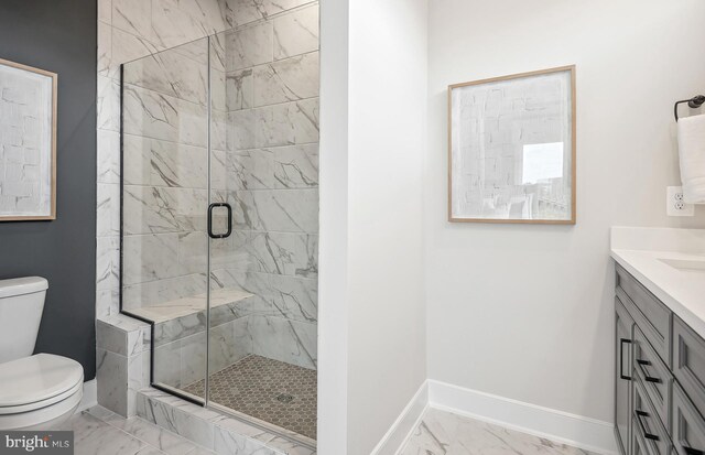 bathroom with walk in shower, vanity, and toilet