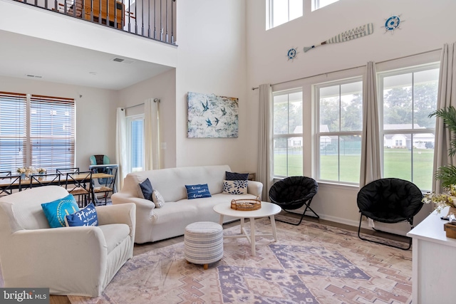 living room featuring a wealth of natural light and a high ceiling