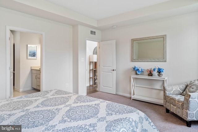 carpeted bedroom featuring ensuite bath