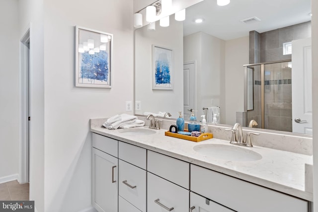 bathroom with vanity, tile patterned floors, and a shower with shower door