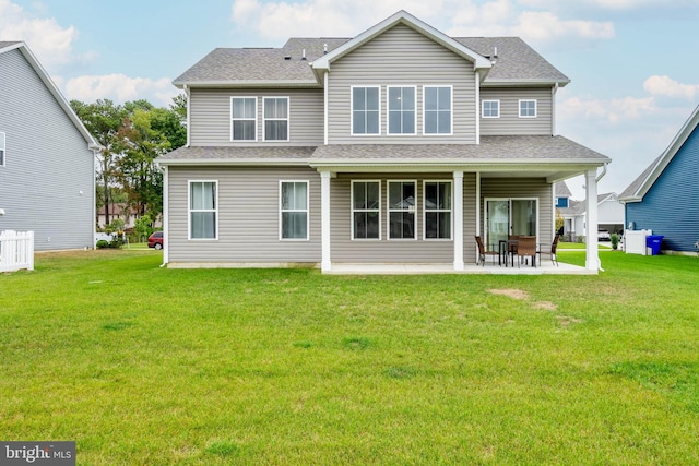 back of house with a lawn and a patio area