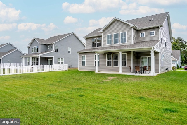 rear view of property with a patio and a yard