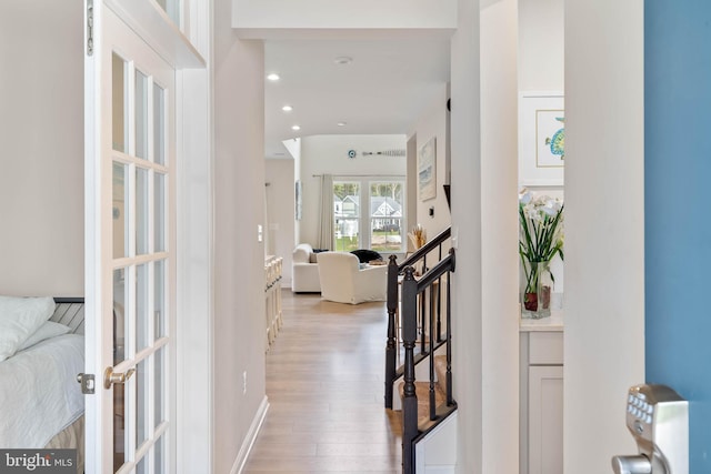 hallway featuring french doors and light hardwood / wood-style flooring