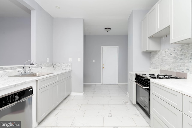 kitchen featuring tasteful backsplash, sink, white cabinets, stainless steel appliances, and light stone countertops