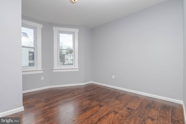 empty room with dark wood-type flooring