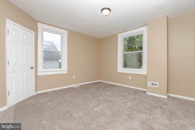 unfurnished room with light carpet