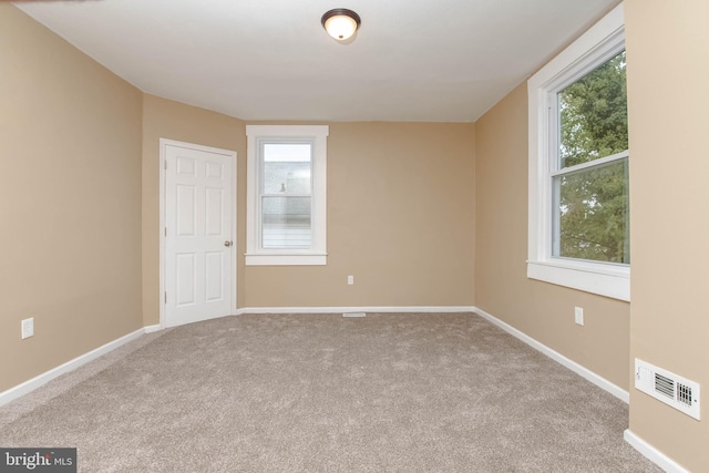 carpeted spare room with plenty of natural light