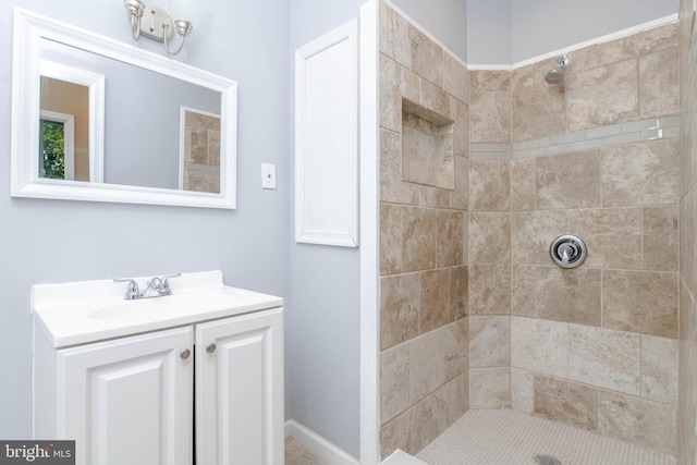 bathroom featuring vanity and tiled shower