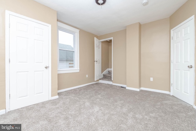 unfurnished bedroom featuring light colored carpet