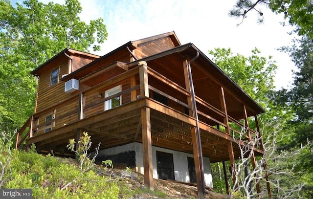 view of home's exterior featuring an AC wall unit