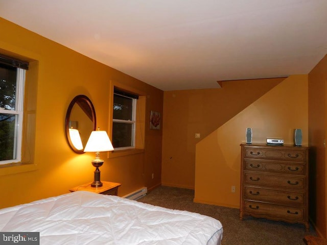 bedroom featuring a baseboard heating unit and dark carpet