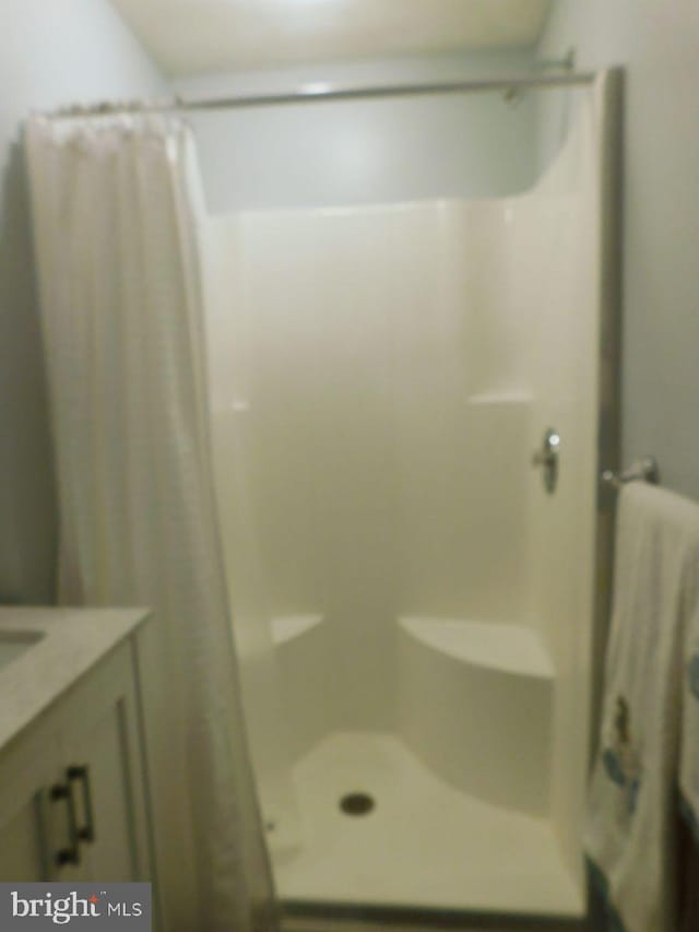 bathroom with vanity and walk in shower