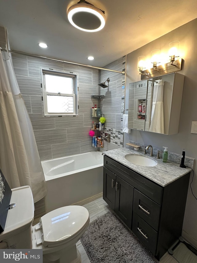 full bathroom featuring vanity, toilet, and shower / bath combo