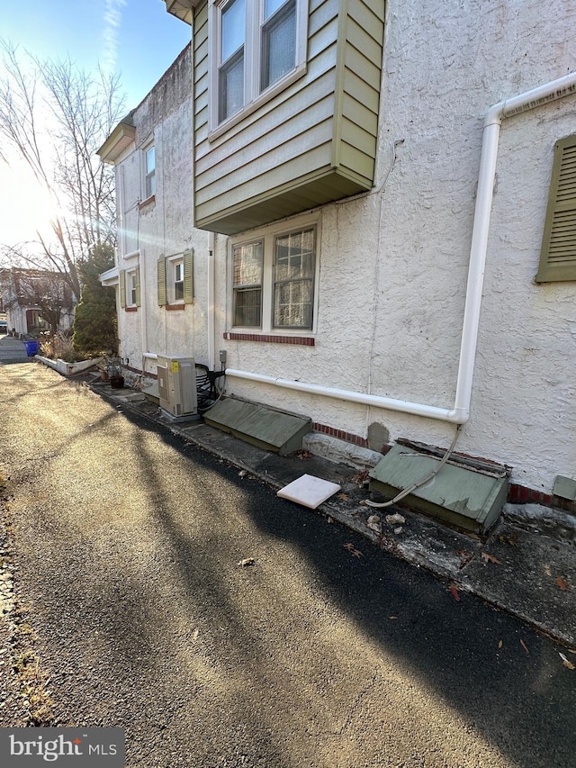 view of side of property featuring central AC