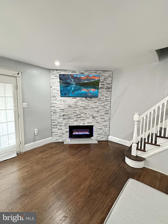 living room featuring a fireplace and wood-type flooring