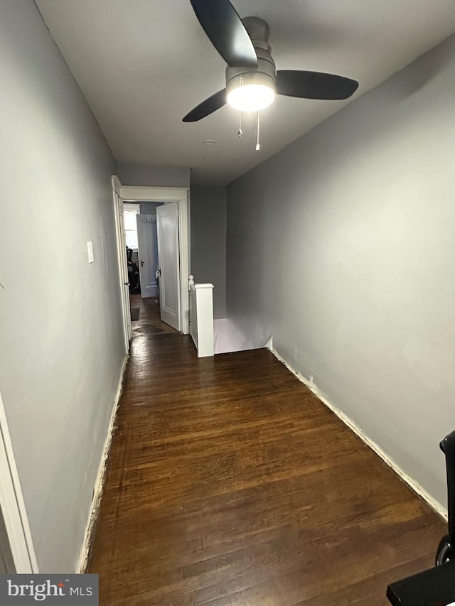 hallway with dark wood-type flooring