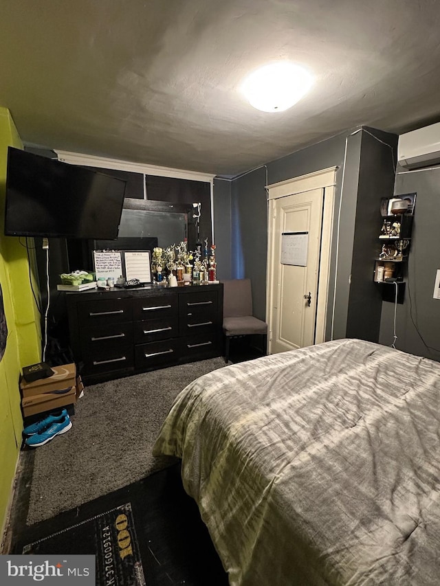 bedroom featuring a wall mounted air conditioner and carpet floors