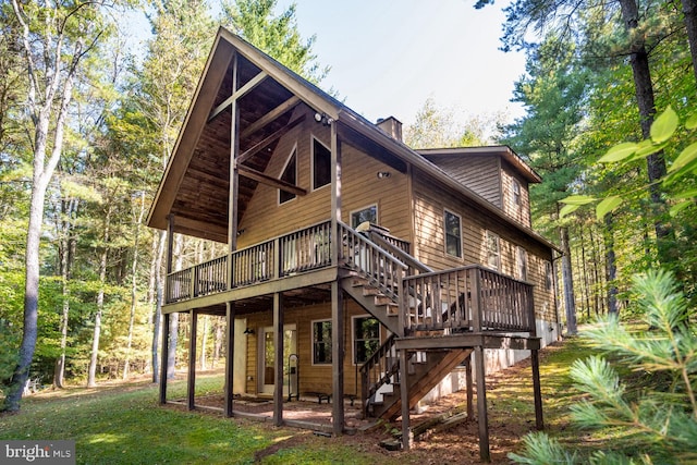 rear view of property featuring a deck