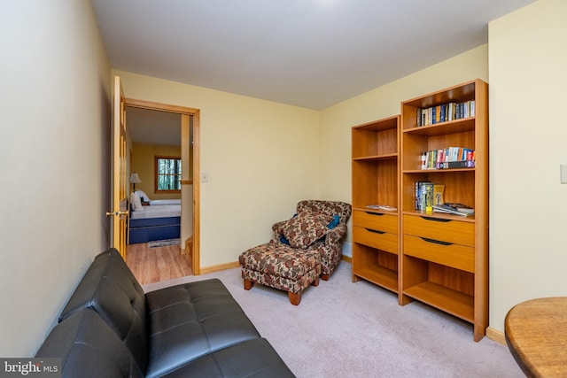 sitting room featuring light carpet