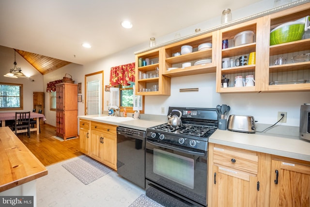 kitchen featuring a healthy amount of sunlight, black appliances, butcher block counters, and pendant lighting